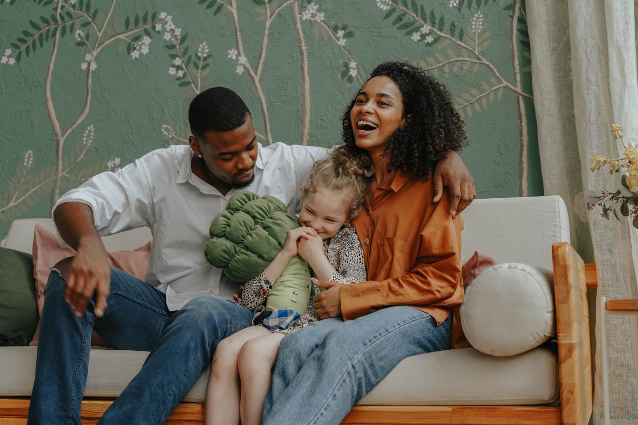 Mother and father smiling and laughing with their child