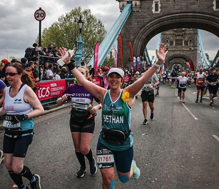 Bethan running across Tower Bridge during the London Marathon