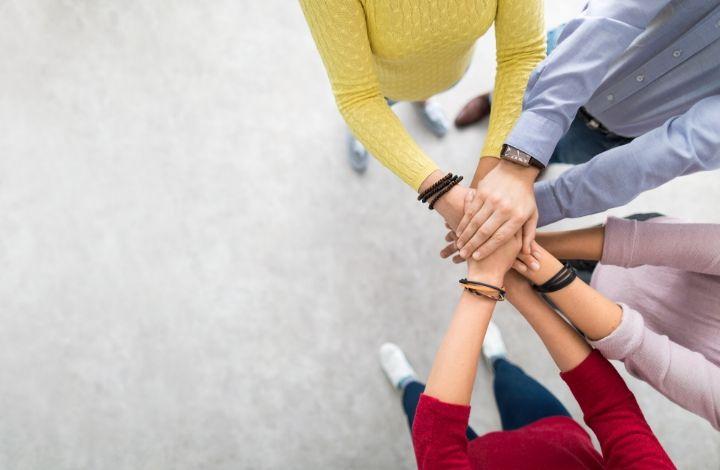 Group of hands coming together
