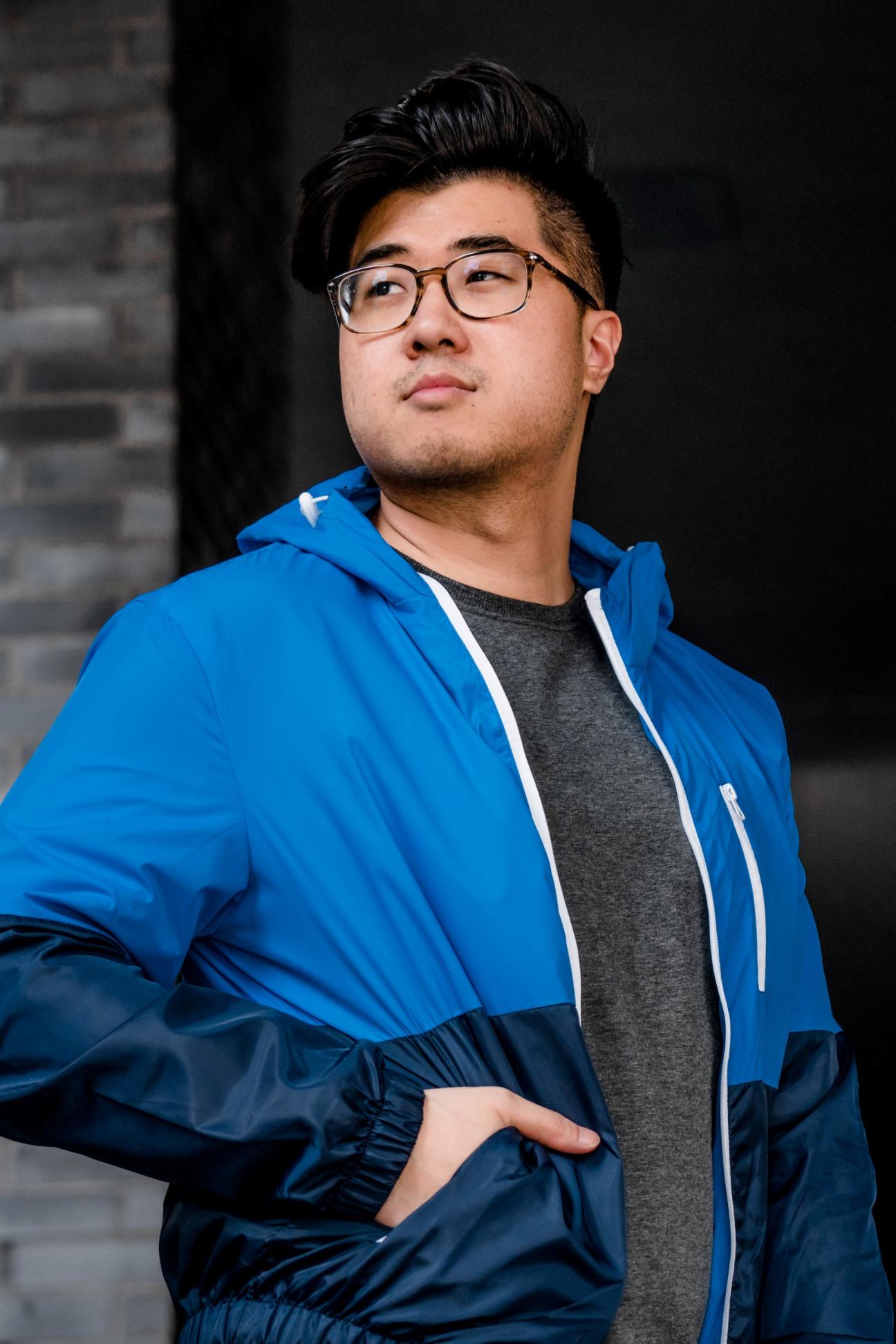 Young man outside in a blue jacket