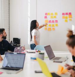 People working around a table and whiteboard