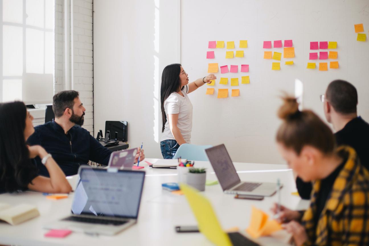 People working around a table and whiteboard