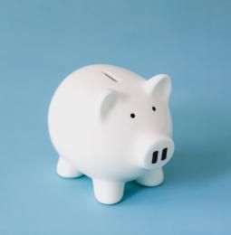 White piggy bank for collecting money on a blue background