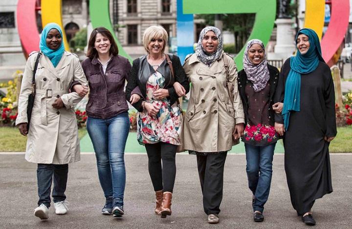 Women smiling in a line