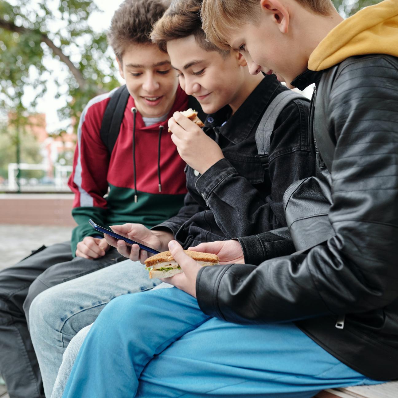 Young boys eating lunch outside